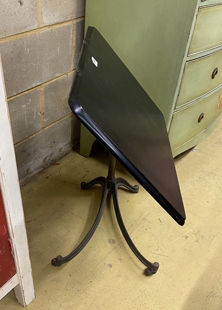 An early 20th century cast iron adjustable reading table